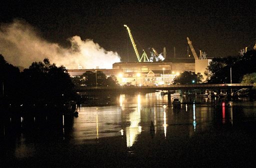 Smoke rises from a dry dock as fire crews respond Wednesday, May 23, 2012 to a fire on the USS Miami SSN 755 submarine at the Portsmouth Naval Shipyard on an island in Kittery, Maine. Four people were injured. (AP Photo/The Herald, Ionna Raptis)