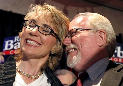 Democratic candidate Ron Barber celebrates his victory with former Rep. Gabrielle Giffords on Tuesday. Barber, Giffords' former district director, won a special election for the seat Giffords left in January to focus on her recovery from a gunshot wound.