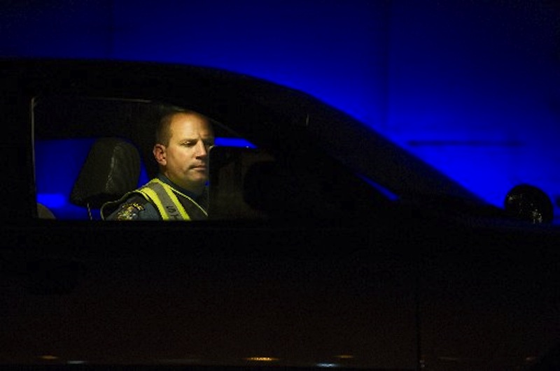In this December 15, 2011 file photo, Maine State Police Trooper Doug Cropper writes an accident report inside his cruiser on I-295. Cropper ised his cruiser to keep a wrong-way driver from getting onto Tukey's Bridge on Friday afternoon, June 29, 2012.