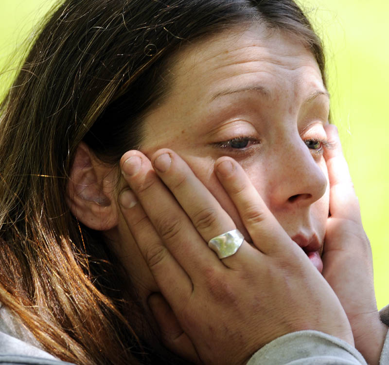 Jennifer Dowling waits to be transported to jail Tuesday morning after being arrested by Augusta police on drug possession charges after drug agents and Augusta police executed a search warrant at 21 Glenwood Street in Augusta.