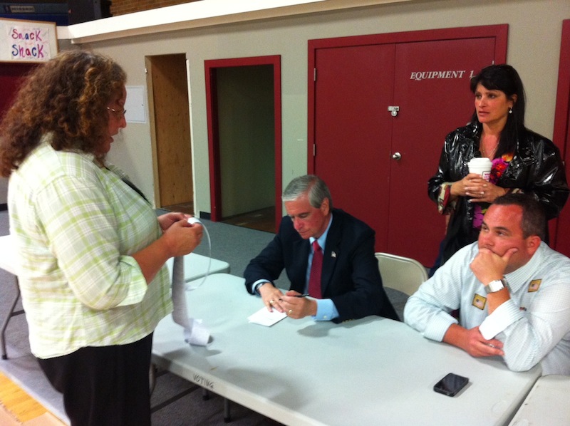 Poll worker Peg Mills reads results from one Saco ward to Don Pilon, center, a Democrat seeking the Senate District 5 nomination, and Tim Sevigny, a Republican running for the same seat.