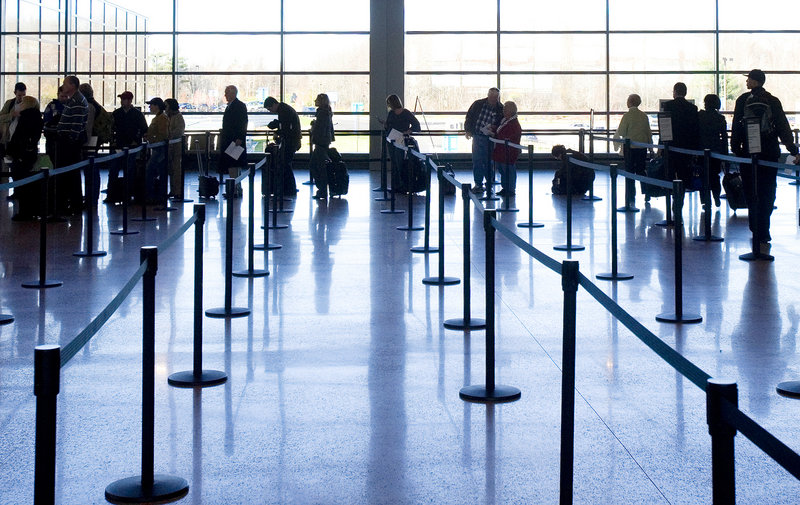 Travelers line up for security screening in the new terminal at Portland International Jetport.