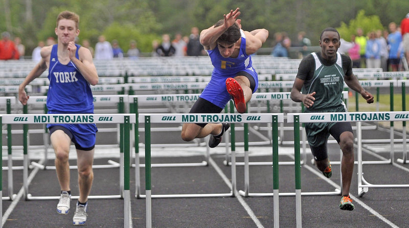 Reid Pryzant of Falmouth was second in the 110 hurdles in Class B. Tom York, left, of York was third and Curtis Griffin of Mt. View, right, was fourth. Ethan Hutchins of Spruce Mountain won.