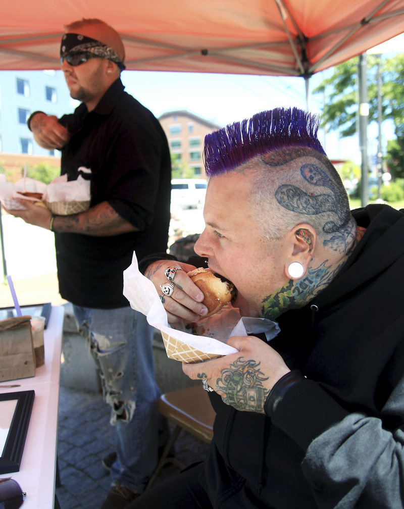 Peter Cordice of Portland, front, and Al Farrisio of Florida are the first to try the Meatball Madness subs from Nonna’s Kitchenette on Sunday.