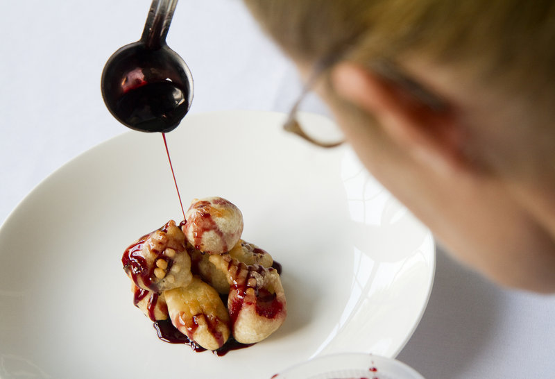 Carmen Gonzales drizzles sauce on her strawberry and banana fritter creation.