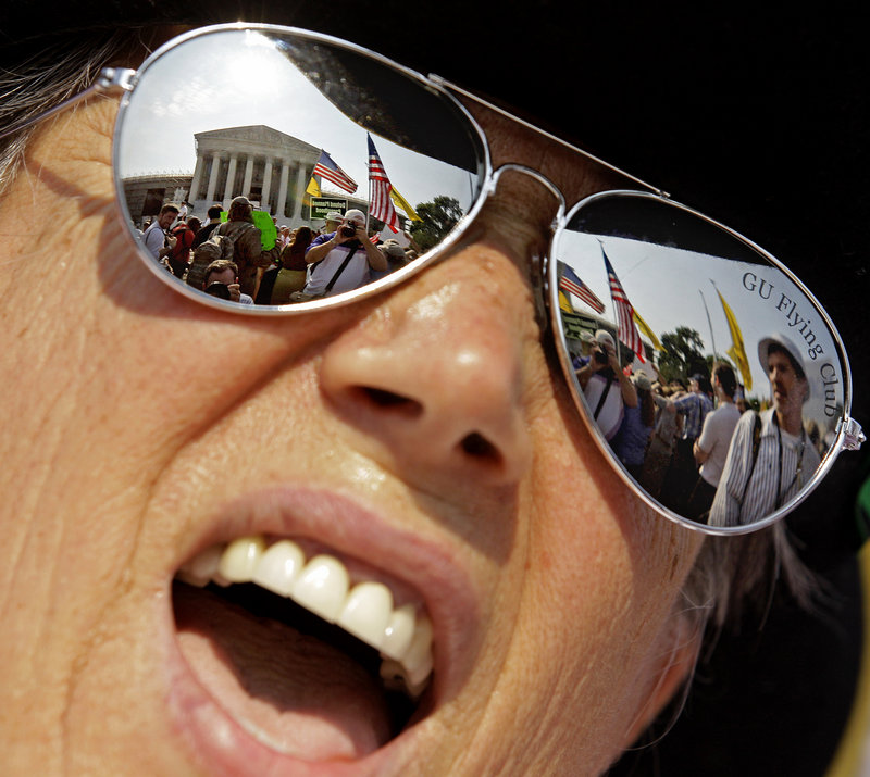 The Supreme Court is close by as Susan Clark of Washington demonstrates against the health care law before the court’s ruling. The court upheld the law 5-4, a tough defeat for Republicans and tea party activists.