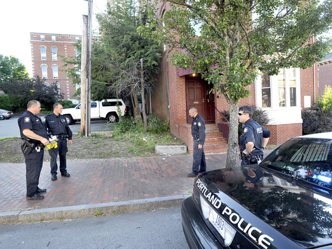 Portland police finish collecting evidence near 105-107 India St., the scene of this morning's fatal shooting.