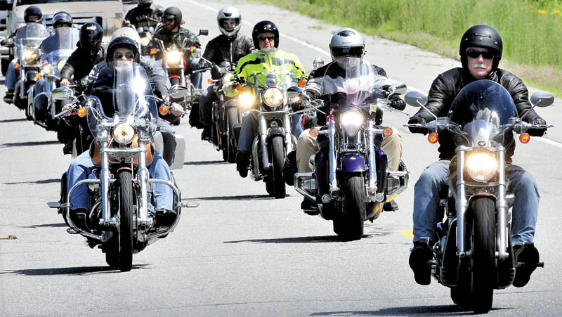 THE ROAD TO NOVEMBER: Angus King, former Maine governor and candidate for U.S. Senate, right, leads a group of motorcyclists after a campaign tour stop in Skowhegan on Wednesday.