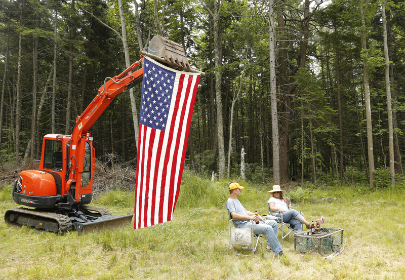Rick and Maggie Morgan of Hampstead, N.H., watch the Chebeague Fourth of July parade from their island property where they are building a house. The Morgans were also celebrating their wedding anniversary on Wednesday.