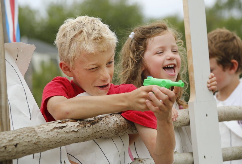 Cooper Israel, 7, squirts the spectators from a float much to the delight of Elizabeth Rugh, 4, during the Chebeague Island Fourth of July parade. Both are from Chebeague Island.