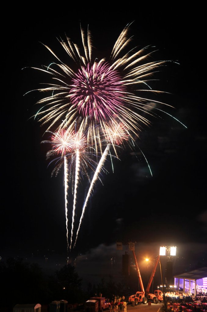 Explosions of light elicit appreciative oohs and aahs on Portland's Eastern Promenade on Thursday night as the city's storm-delayed fireworks display went on at last.