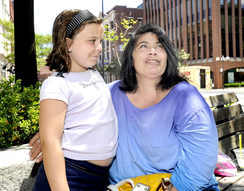 Independent voter Elizabeth Sellner of Portland, with her daughter Maiah, says she plans to vote for Mitt Romney because “it’s time to move on” from President Obama.