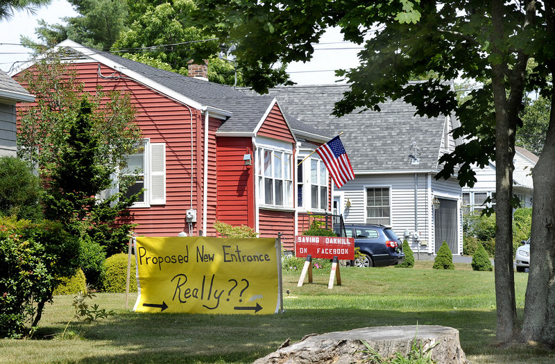 Signs near the planned site of Wegman Cos.’ project on Black Point Road express a neighbor’s opposition.