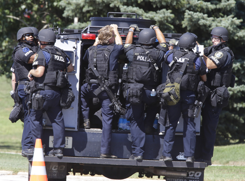 Police personnel move outside the Sikh temple Sunday.