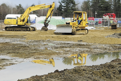 Staff file photo by Joe Phelan A worker operates a bulldozer at the oil spill cleanup site in Manchester on March 13. J&S Oil now faces federal sanctions, including a potential fine of up to $177,500, as the result of the March 8 incident in which some 1,500 gallons of oil spilled onto the ground and spread to a neighboring property and drainage ditches.