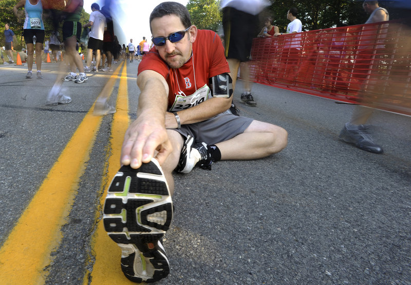 Sean Kelly of Standish finds a spot to stretch before the start of Saturday’s race.