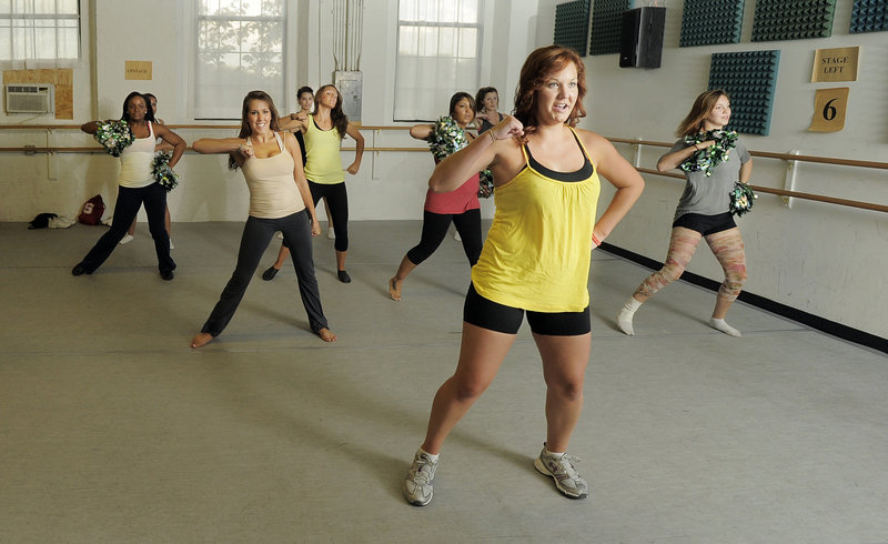 Alicia Owens of South Portland, front in yellow, leads a group of young women as they audition for the Maine Red Claws dance team Tuesday at the Drouin Dance Center in Westbrook. Final decisions will likely be made Sunday.