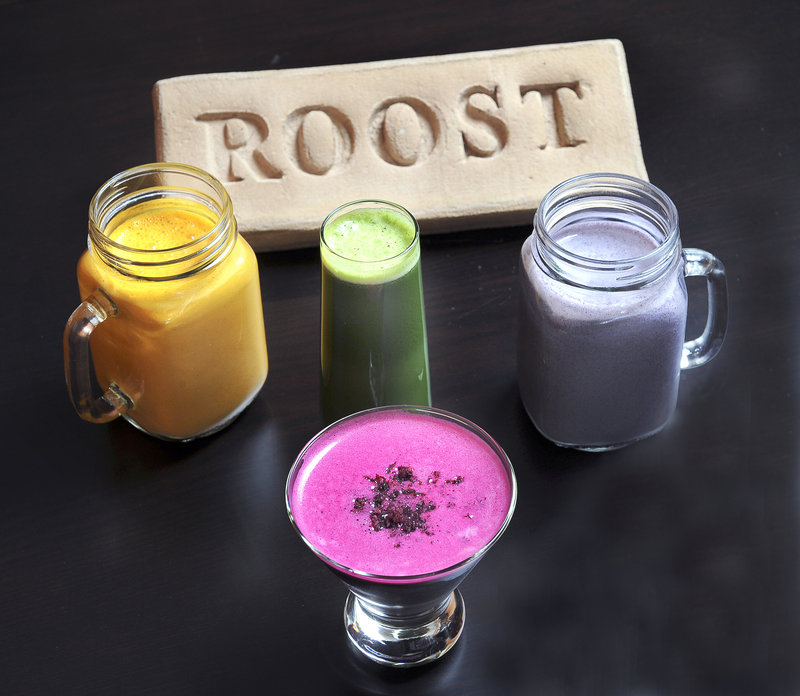 Beverages featured at Roost include, clockwise from left, Carrot Cake Smoothie, which tastes like its namesake with a mix of carrot juice, ginger, nutmeg and raisins; Regulator, a green juice concoction of kale, spinach, romaine lettuce, cucumber, celery, lemon and apple; AB&J Protein Smoothie (or almond butter & jelly), made with a mix of almond milk, almond butter, blueberries, flax seeds, hemp seeds and tahini; and Fancy-Full Juice Shaktini, served in a martini glass and made from beets, apples and blueberries garnished with a touch of beet pulp.