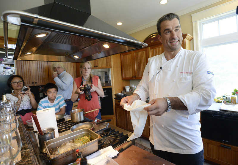 German chef Gerd Kastenmeier prepares sausage for his dish, a Maine lobster trio of lobster tartare topped with a fried quail egg, Maine lobster tail sausage over champagne kraut, and scrambled egg with lobster knuckles topped with caviar.