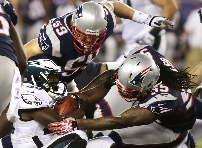 Brandon Spikes, 55, and Bobby Carpenter of the Patriots stop Philadelphia Eagles running back LeSean McCoy in Monday night’s preseason game at Foxborough, Mass. The Eagles won, 27-17.