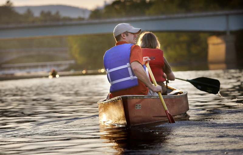 Jonathan LaBonte, executive director of the Androscoggin Land Trust and the mayor of Auburn, paddles the Androscoggin River, watching the fruition of his group’s work over the years.