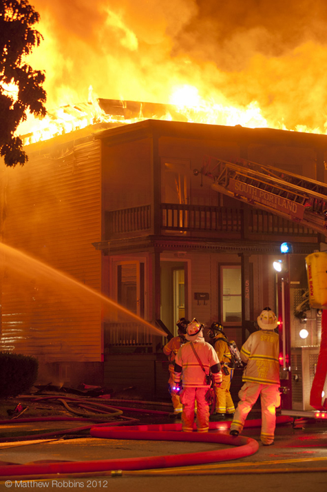 Firefighters on the scene of a fire that destroyed a two-story building Wednesday at 554 Main St. in South Portland.