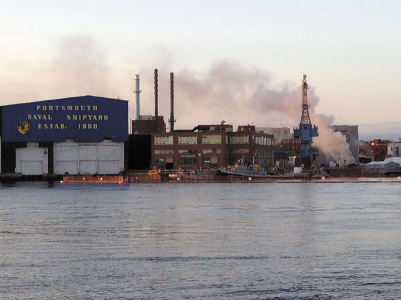 In this May 23, 2012 file photo, a fire burns on a nuclear submarine at the Portsmouth Naval Shipyard in Kittery, Maine. A civilian employee working as a painter and sandblaster aboard the submarine has been charged with setting a fire that caused $400 million in damages to the vessel in May, and a second fire near it in June, Navy investigators said in a complaint filed Monday, July 23, 2012. (AP Photo/WMUR, Jean Mackin, File)
