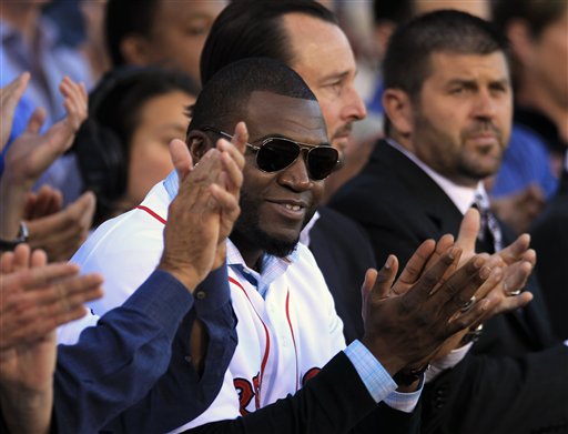 Boston Red Sox's David Ortiz, center front, applauds with former Red Sox players Tim Wakefield, center right, and Jason Varitek, right, during ceremonies held to honor the life of the late Johnny Pesky at Fenway Park, in Boston, Sunday, Sept. 23, 2012. Pesky, who died in August at the age of 92, was a player, manager, and coach for the team. The Associated Press photo