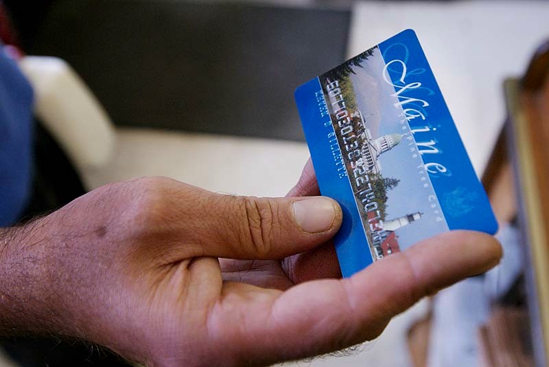 In this August 2008 file photo, Keven Gillette of Portland uses a magnetic food stamp card to buy his groceries. Maine food-stamp recipients who erroneously received extra benefits last year will not be required to repay the government, according to a letter sent this week to Department of Health and Human Services Commissioner Mary Mayhew.