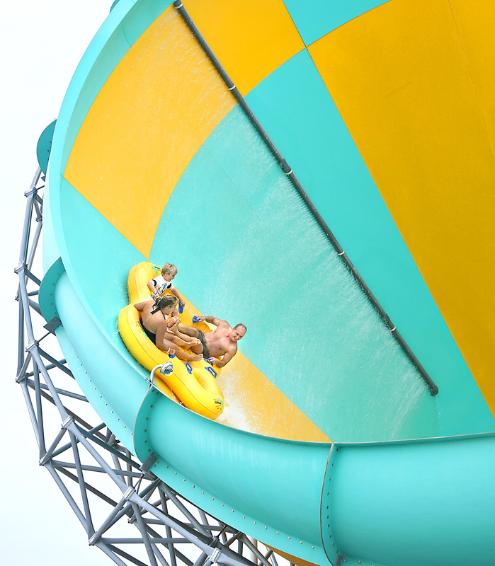 Peter Greene, his son Harry, 8, of Portland, and their friend Christine Byrne of Cumberland ride the Tornado on Friday at Funtown Splashtown USA, which saw an increase in tourists from Canada and southern New England this summer.