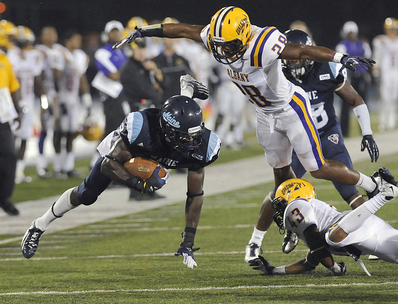 Maine wide receiver Maurice McDonald (2) makes a reception under pressure from Albany free safety Justinian Mason (28) and Jojo McLary (43) in the second half Saturday.