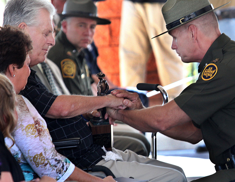 Kent Terry Sr., father of Border Patrol Agent Brian Terry, and Richard "Rick" Barlow, chief patrol agent of the Tucson sector, share a quiet moment during the dedication ceremony for a new station named after Brian Terry on Tuesday in Naco, Ariz. Brian Terry was killed in a December 2010 firefight with bandits north of the Mexican border. Two guns found at the scene were bought by a member of a gun smuggling ring that was being monitored in the government's botched gun smuggling probe known as Operation Fast and Furious.