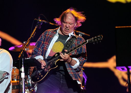 Neil Young performs with his band Crazy Horse at the Global Citizen Festival on Saturday. The free concert in New York's Central Park drew about 60,000 music fans. Organizers used an innovative approach to ticket distribution so that many concert-goers were forced to learn about an array of global problems.