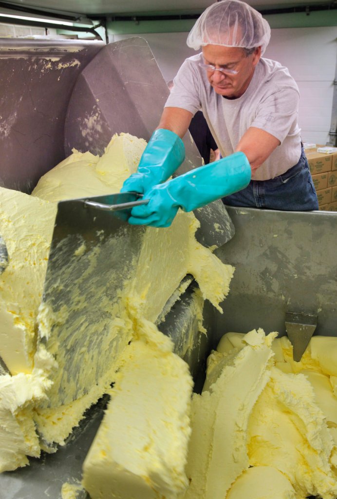 Dan Patry carves off chunks of butter into a vat at Kate's Homemade Butter in Old Orchard Beach on Tuesday, April 12, 2011. Patry started the company in 1981 with his wife.