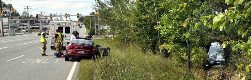 The van driven by Horace Crawford sits deep in the woods off Kennedy Memorial Drive just before Shaws Plaza on Thursday. Crawford lost consciousness while driving west on Kennedy Memorial Drive in Waterville.