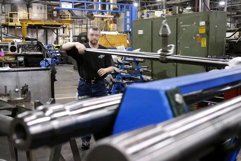 In this January 2007 file photo, David McKnight moves a machine gun barrel to a polishing machine at the General Dynamics Armament and Technical Products Operation in Saco which manufactures machine guns and other weapons systems for the military. General Dynamics announced Tuesday it was laying off 30 from the Maine plant.