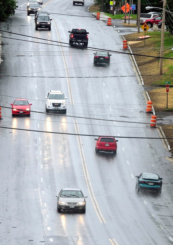 Cars head south on State Street between the State House and King Street on Friday afternoon in Augusta. When the the road is repaved soon, plans call from changing it from two lanes in each direction to one lane in each direction with a center turn lane in between.