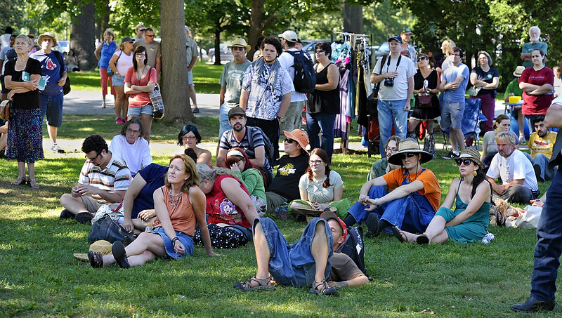 Some of those attending the Atlantic CannaFEST at Deering Oaks in Portland listen to music, speakers and promotions of medical marijuana on Saturday.