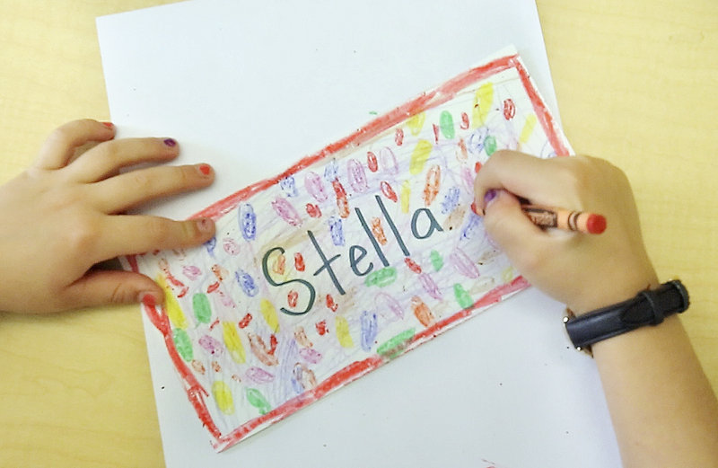 First-grader Stella Halstead colors a name tag during the first day of school at East End School in Portland on Thursday, Sept. 6, 2012.