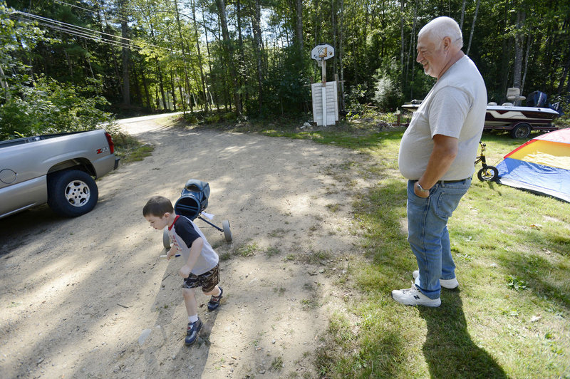 Richard Dyer of Lebanon watches his grandson Joey Dyer, 3, as he plays in the yard Tuesday. Thirty farm-raised pheasants died recently in Lebanon from Eastern equine encephalitis. It’s rare in humans, and only a few cases are reported in the U.S. annually.