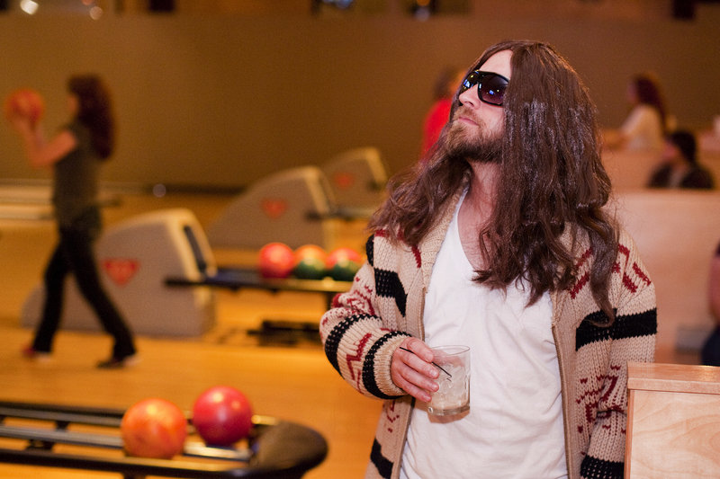 Rob Calder of South Portland watches the action Friday at Bayside Bowl in Portland, where the third annual Viva Lebowski fundraiser was getting under way. Calder was portraying Jeff Bridges’ “The Dude” from the 1998 film “The Big Lebowski.” The bowling and movie screening party benefits United Way of Greater Portland.