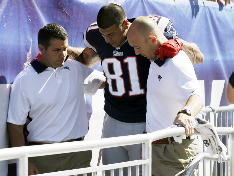 Patriots tight end Aaron Hernandez is helped to the locker room after he sustained an ankle injury in the first quarter Sunday against Arizona. He did not return.