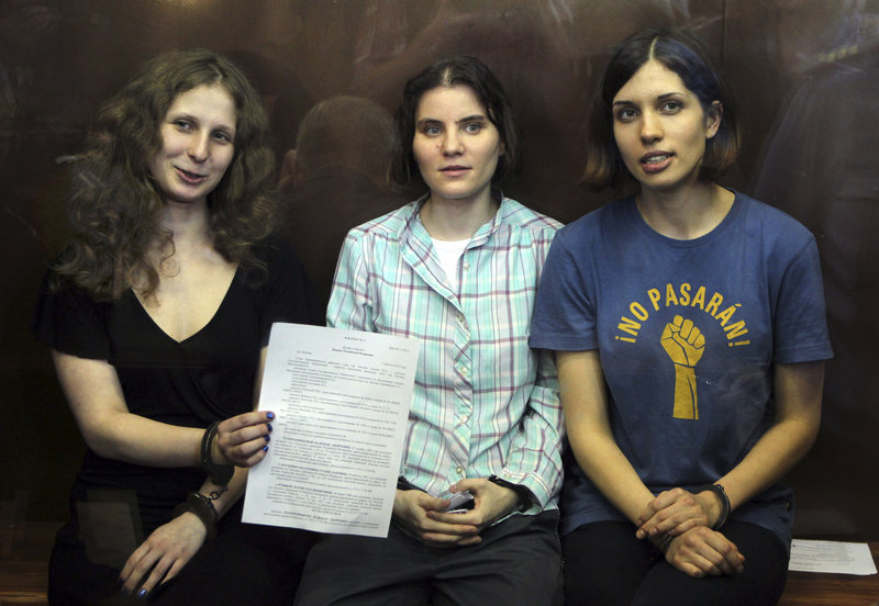 Members of the feminist punk group Pussy Riot, from left, Maria Alekhina, Yekaterina Samutsevich and Nadezhda Tolokonnikova, are seen this summer inside a glass cage at a courtroom in Moscow where they were convicted of “hooliganism” and sentenced to two years in prison.