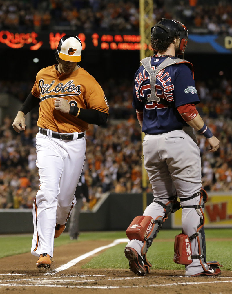 Baltimore’s Chris Davis crosses the plate behind Boston catcher Jarrod Saltalamacchia during the Orioles’ 4-3 win in Baltimore on Saturday.