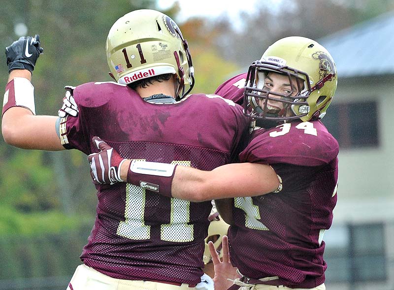 Nick Kenney 34, is congratulated by Eric Christensen after scoring Thornton Academy's third touchdown Saturday in a 35-7 win over Scarborough.