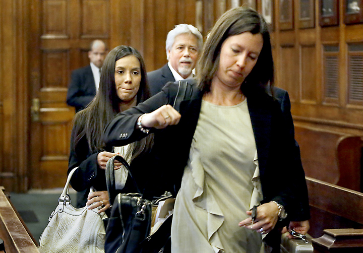 Alexis Wright follows her lawyer, Sarah Churchill, out of the courtroom, as Mark Strong Sr. talks with his lawyer after their arraignments at the Cumberland County Courthouse in Portland on Tuesday.