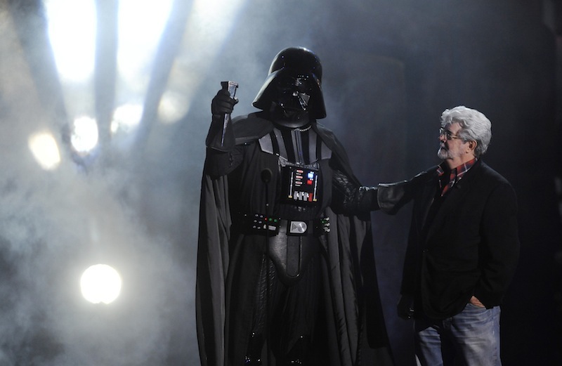 In this Oct. 15, 2011 file photo, "Darth Vader" accepts the Ultimate Villain award from "Star Wars" creator George Lucas during the 2011 Scream Awards, in Los Angeles. A decade after George Lucas said "Star Wars" was finished on the big screen, a new trilogy is destined for theaters after The Walt Disney Co. announced Tuesday, Oct. 30, 2012, that it was buying Lucasfilm Ltd. for $4.05 billion. (AP Photo/Chris Pizzello, File)