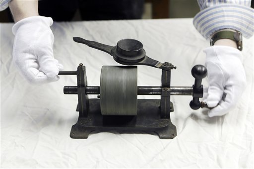 Josh Hauk, an archival assistant at the Museum of Innovation and Science, demonstrates the use of an 1879 tinfoil phonograph on Wednesday in Schenectady, N.Y.