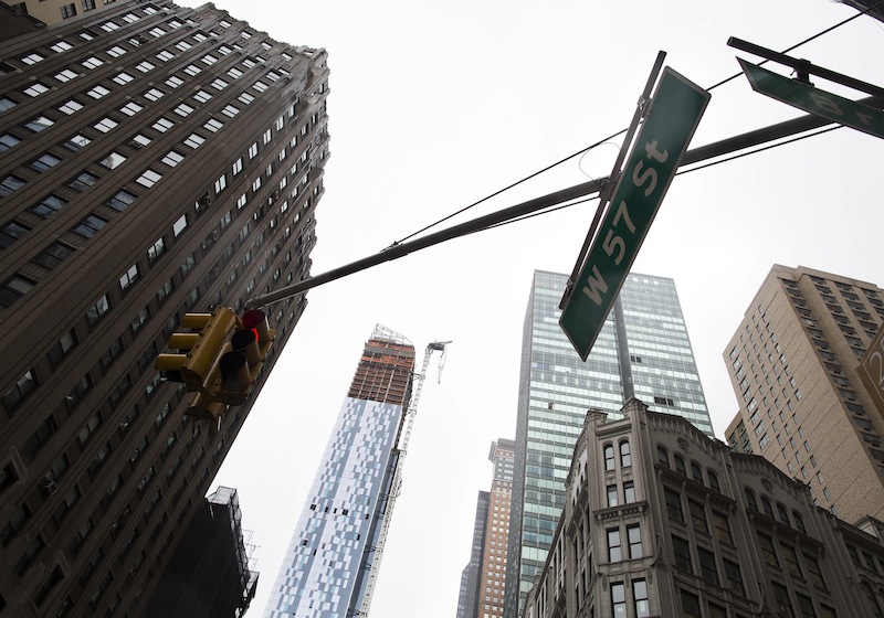 A construction crane atop a luxury high-rise dangles precariously over the streets after collapsing in high winds from Hurricane Sandy, Monday, Oct. 29, 2012, in New York. Hurricane Sandy bore down on the Eastern Seaboard's largest cities Monday, forcing the shutdown of mass transit, schools and financial markets, sending coastal residents fleeing, and threatening a dangerous mix of high winds, soaking rain and a surging wall of water up to 11 feet tall. (AP Photo/John Minchillo)