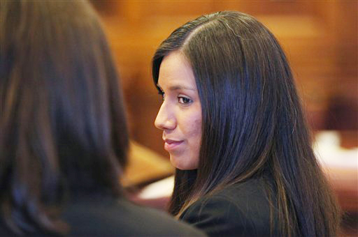 Alexis Wright, 29, turns towards her attorney Sarah Churchill, left, during her arraignment in Portland in this Oct. 9, 2012, photo. She faces 109 counts of prostitution, violation of privacy, tax evasion and other charges for allegedly providing sex for money at her Kennebunk fitness studio and office.